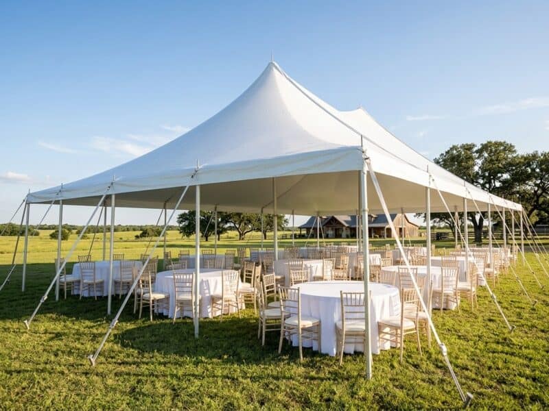 40x60 WIND pole tent open sides with round tables and chiavari chairs set for a wedding reception on a North Texas ranch — Boot & Barrel Event Co. Venus TX
