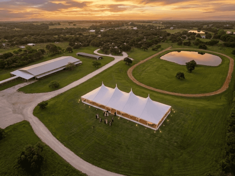 Outdoor wedding tent setup at sunset — Boot & Barrel Event Co. serving Cleburne and Johnson County TX