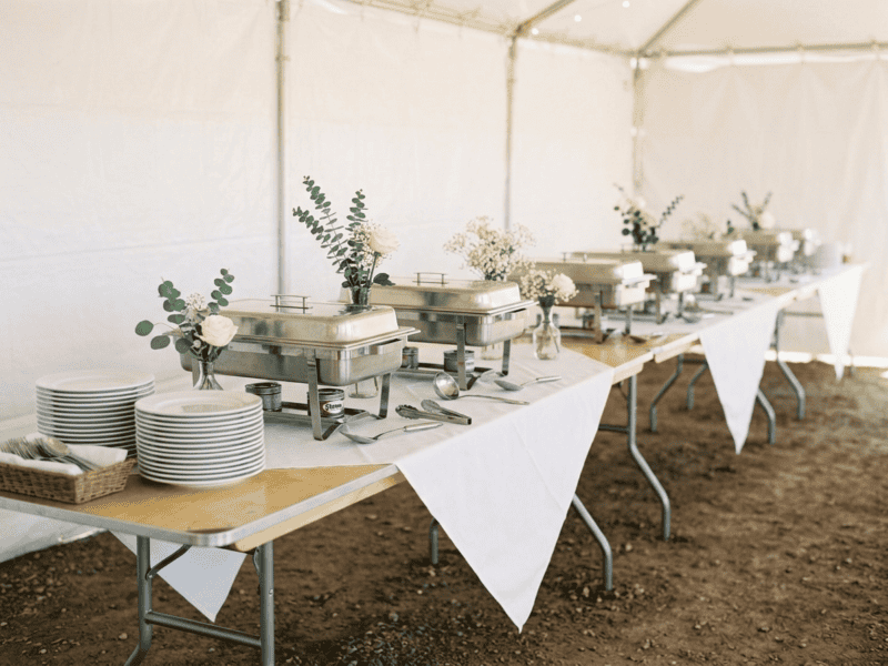 8 foot x 30 inch birchwood banquet table set up as buffet line with chafing dishes under tent in Fort Worth Texas