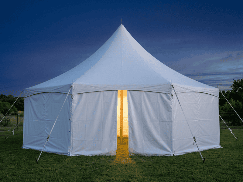 Caterer's package 20x20 high peak tent with sidewalls and work light at dusk — Boot & Barrel Event Co. Joshua TX