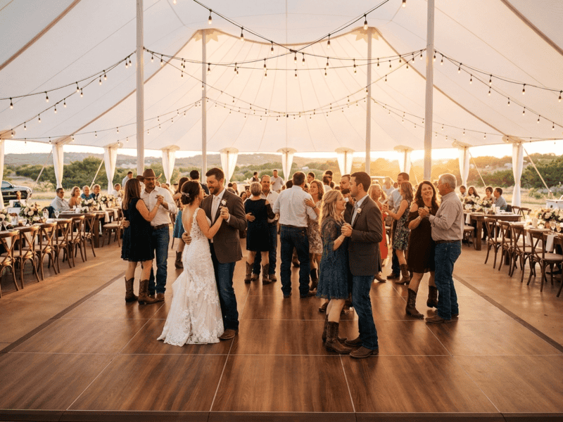 Fruitwood portable dance floor rental with couples dancing at a wedding reception under a white tent — Boot & Barrel Event Co. Cleburne TX