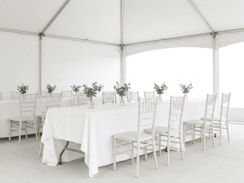Distressed white chiavari chair paired with linen banquet table in Midlothian TX — Boot & Barrel Event Co. rental