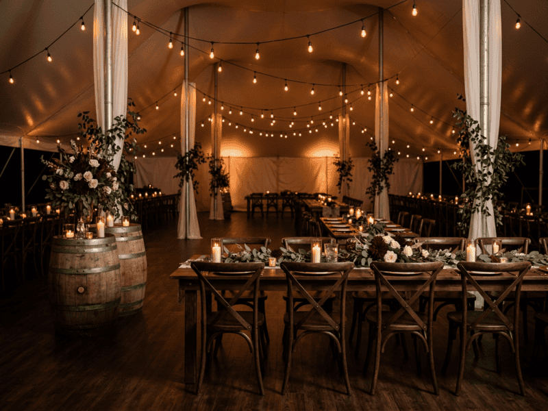 Fruitwood cross-back chair at night reception under tent in Alvarado TX — Boot & Barrel Event Co. rental