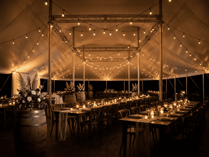 Fruitwood cross-back chair at night reception under tent in Grandview TX — Boot & Barrel Event Co. rental