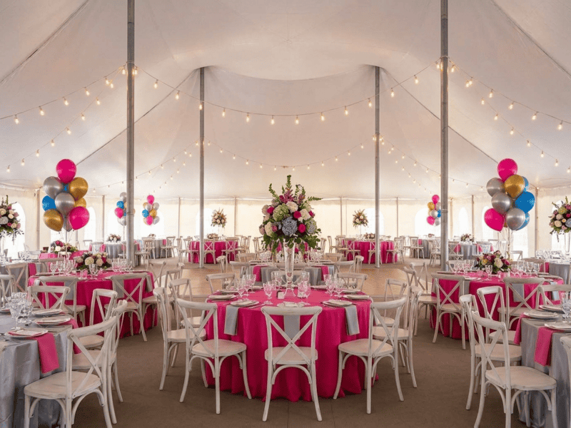 Distressed white cross-back chair at birthday party under tent in Rio Vista TX — Boot & Barrel Event Co. rental