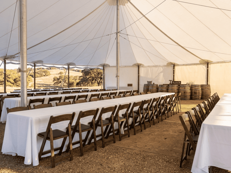 Fruitwood folding chair at corporate event under tent in Fort Worth TX — Boot & Barrel Event Co. rental