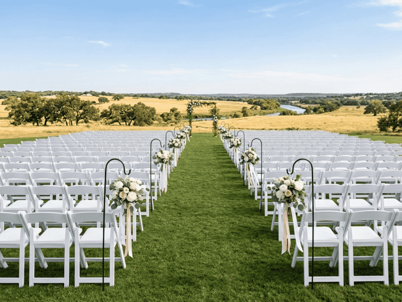 White folding chair at ceremony seating on the Brazos River — Boot & Barrel Event Co. rental