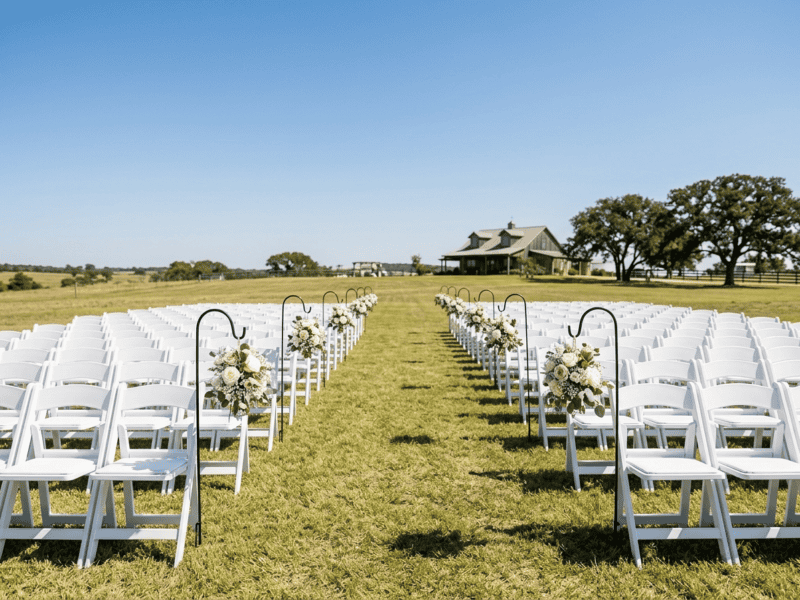 White folding chair at ceremony seating on Texas ranch — Boot & Barrel Event Co. rental