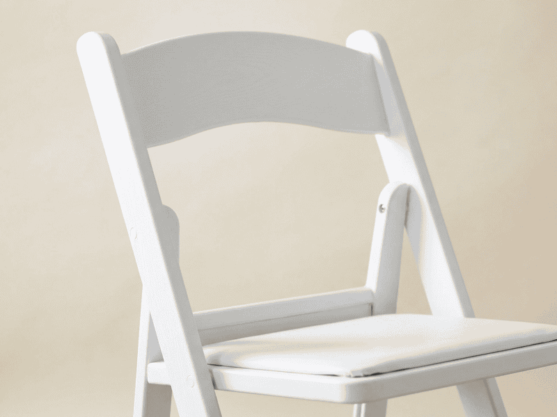 White folding chair detail shot in Texas — Boot & Barrel Event Co. rental