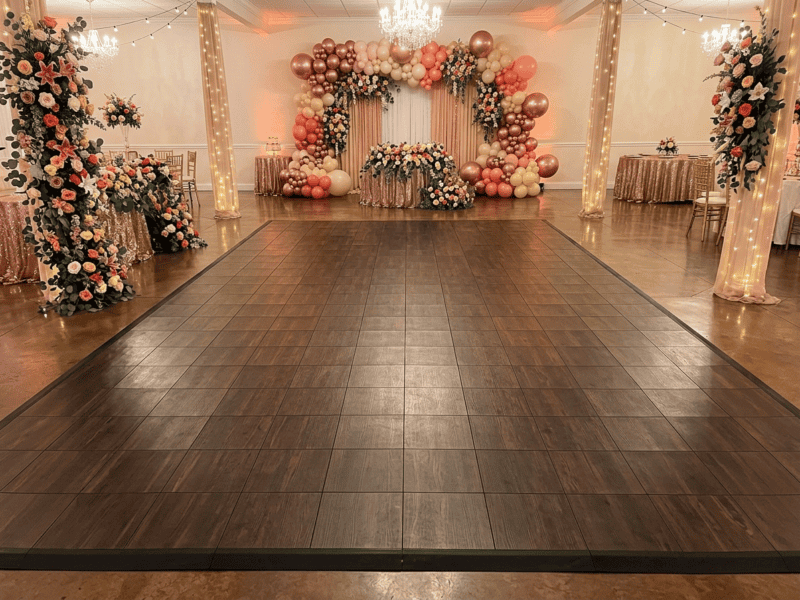 Espresso oak indoor dance floor rental at a quinceanera venue with colorful floral decorations — Boot & Barrel Event Co. Midlothian TX