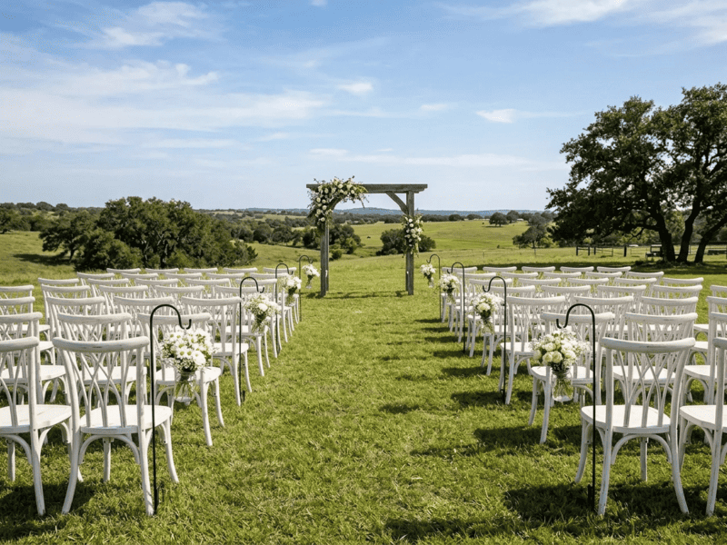 Distressed white willow chair at ceremony seating on Texas ranch — Boot & Barrel Event Co. rental