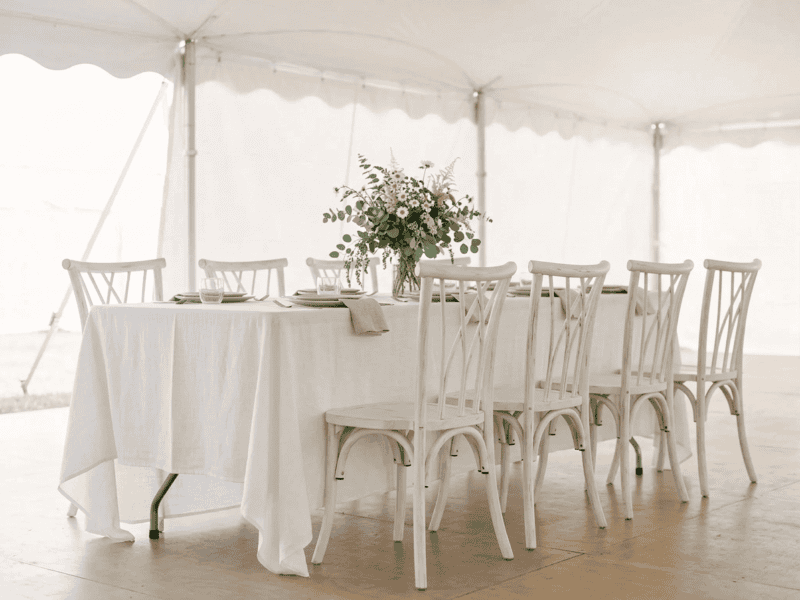 Distressed white willow chair paired with linen banquet table in Midlothian TX — Boot & Barrel Event Co. rental